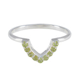 Naomi green gemstone crown ring with small round green stones set in silver band